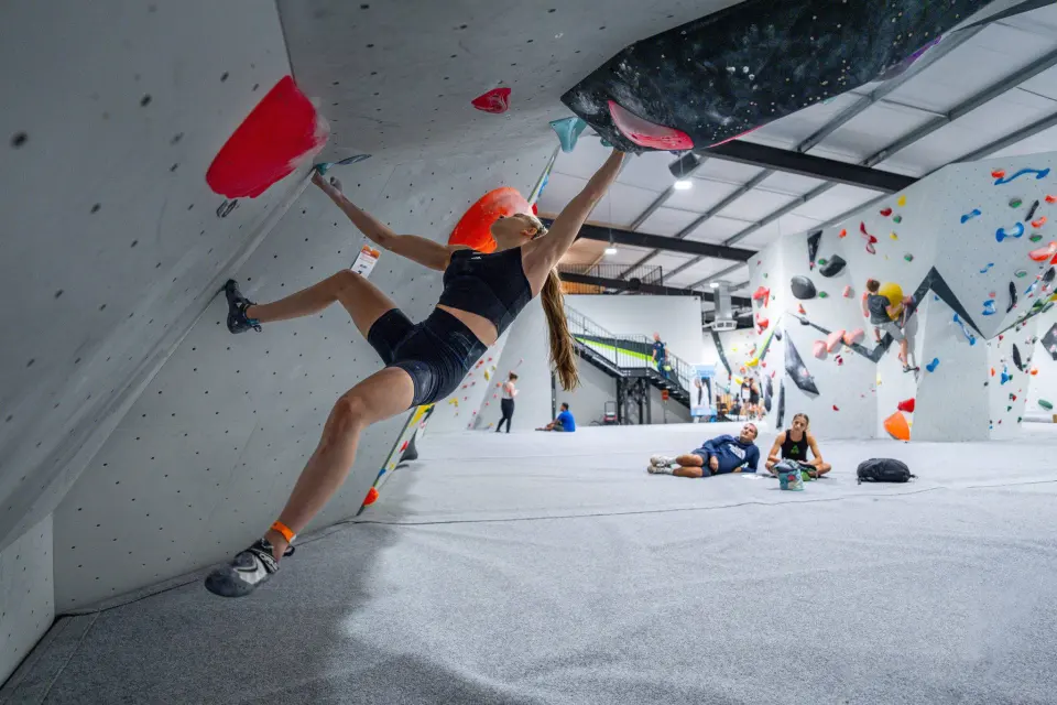 Climber on an overhanging problem in the main bouldering gym