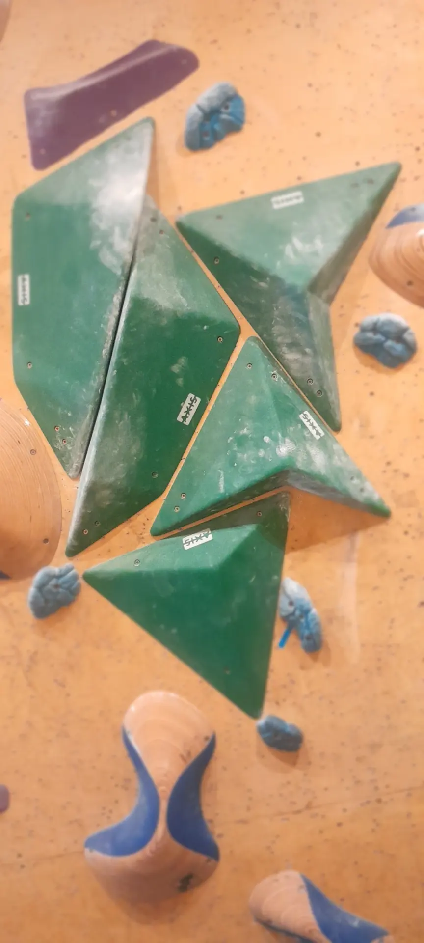 Cluster of green triangular volumes on the wall