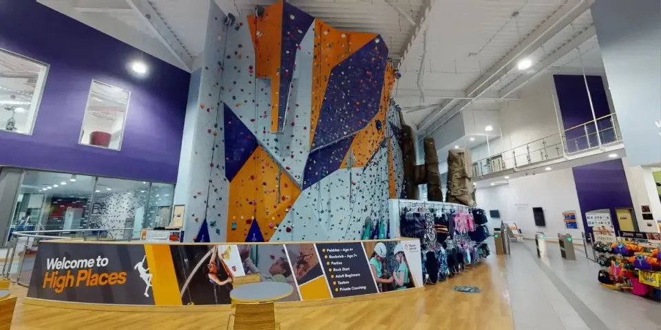 Purple, orange and grey roped climbing wall in the leisure centre's main hall