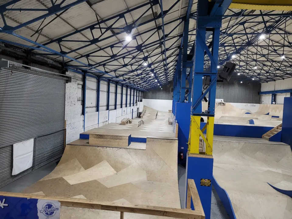 Indoor skatepark ramps in the warehouse beside the bouldering room