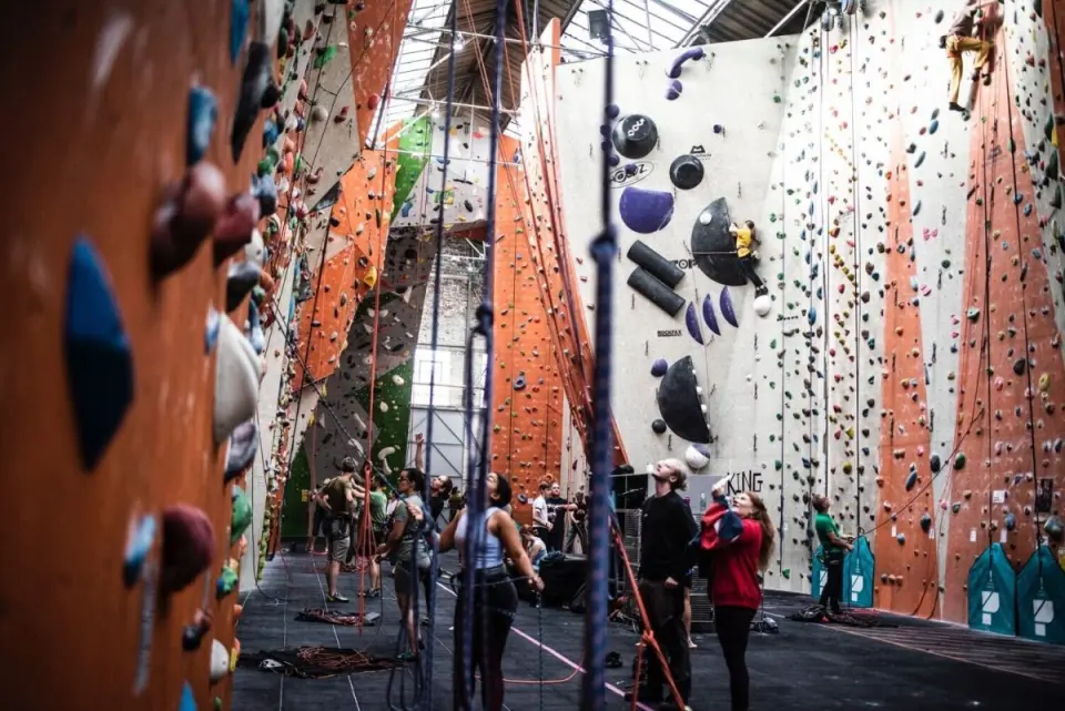 Tall orange and white roped walls under the hall's glazed roof