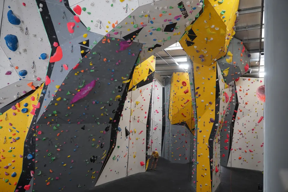 Grey and yellow roped climbing walls in the High Walls arena