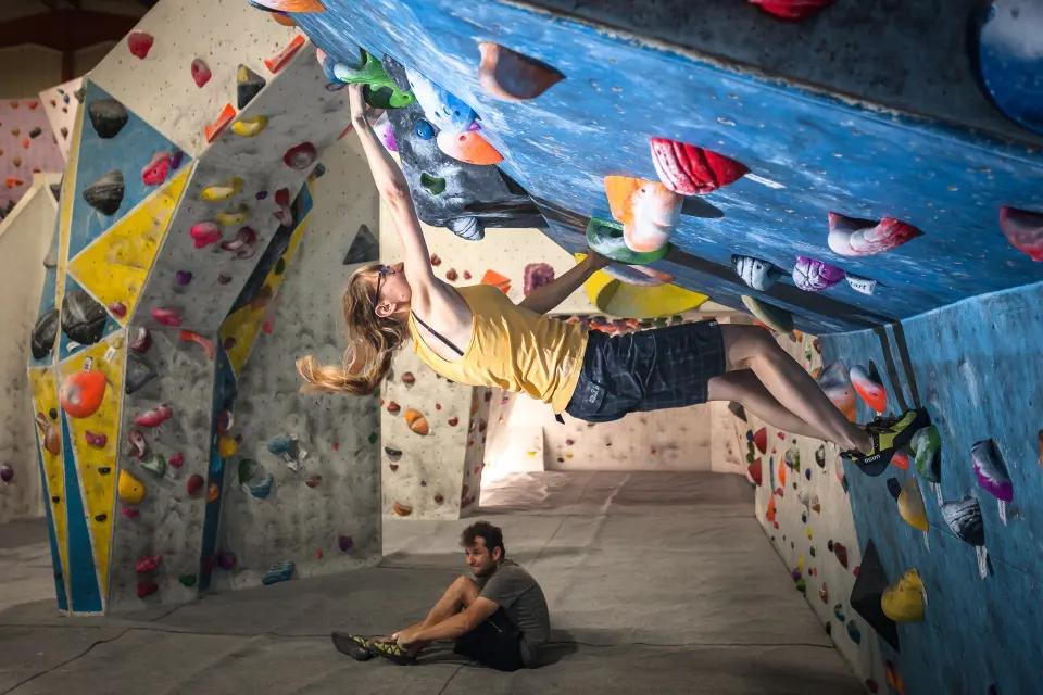Climber on the overhanging bouldering wall