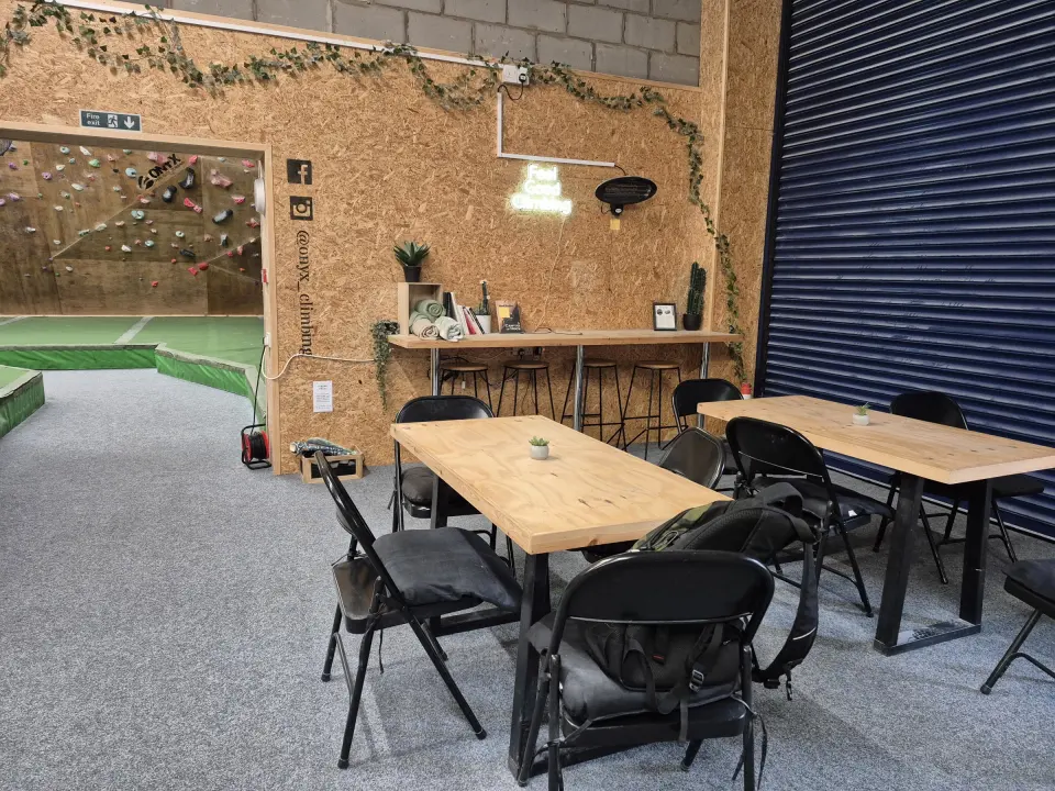 Café tables beside the shutter door and bouldering room