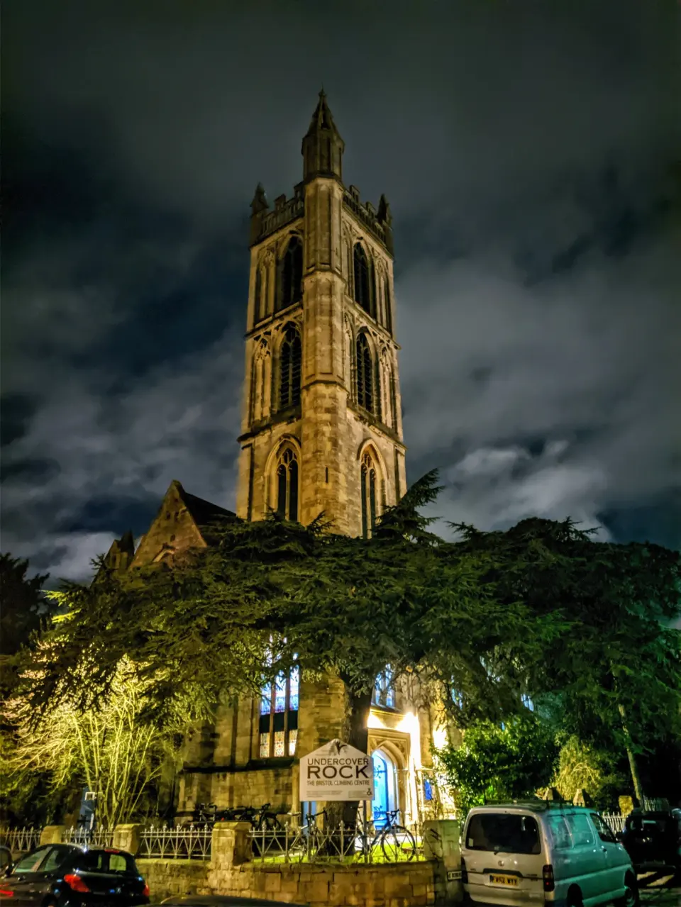 The church tower and entrance lit up at night