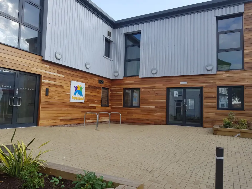 Timber-clad courtyard entrance of the free@last centre