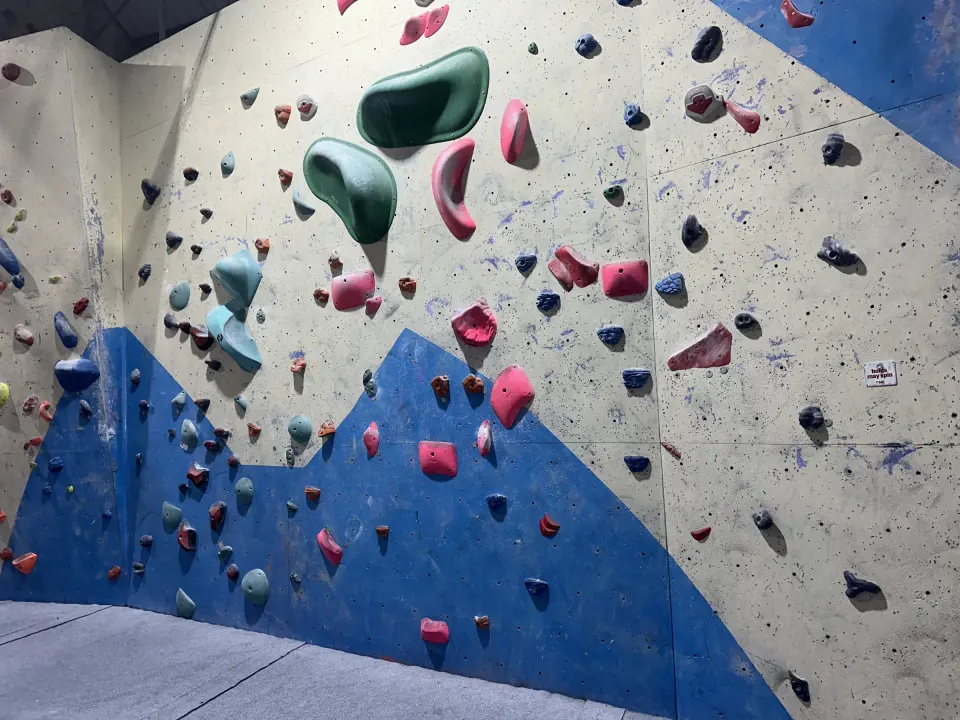 Blue and cream bouldering wall with large volumes