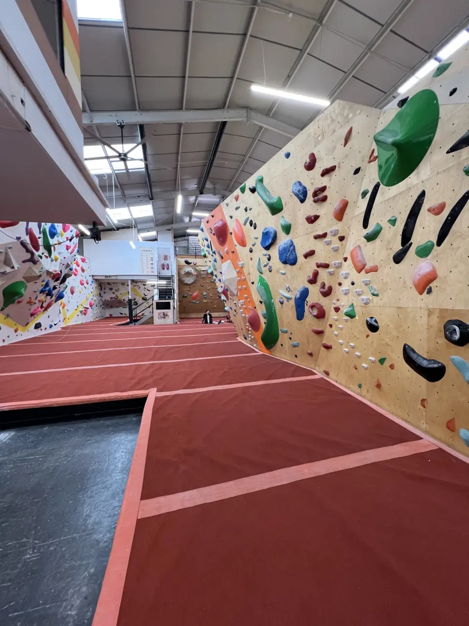 Bouldering wall with large volumes over red matting