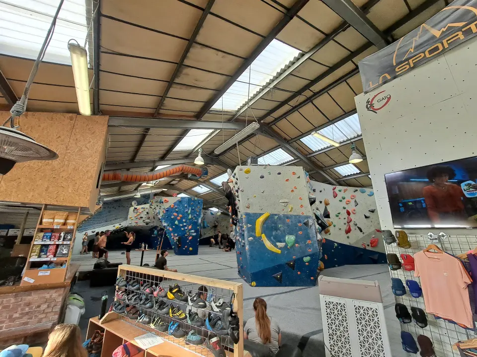 Shoe racks and shop beside the bouldering walls