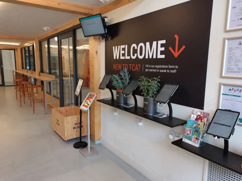 Reception lobby with check-in tablets and welcome sign