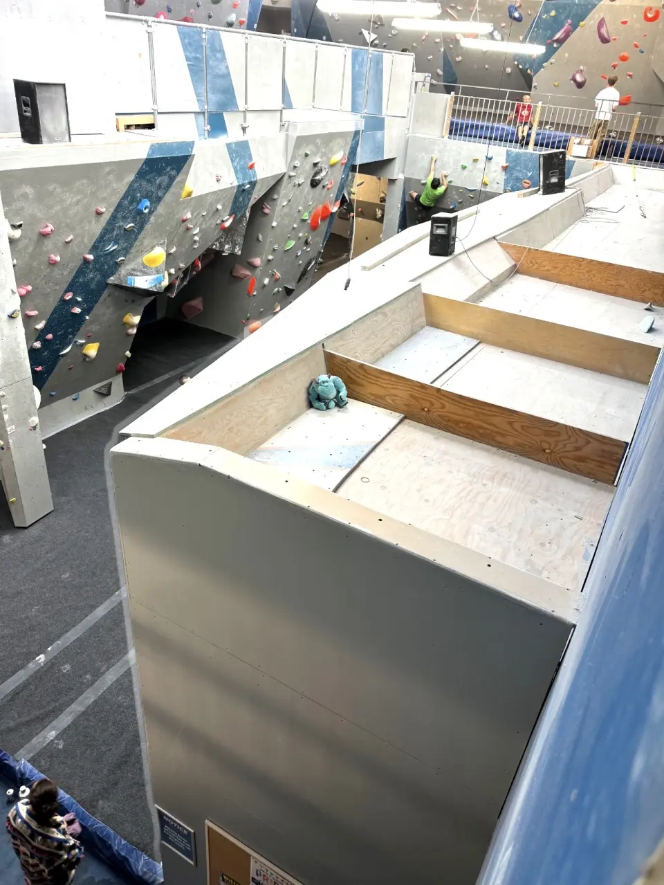 Upper-level bouldering walls seen from a raised platform