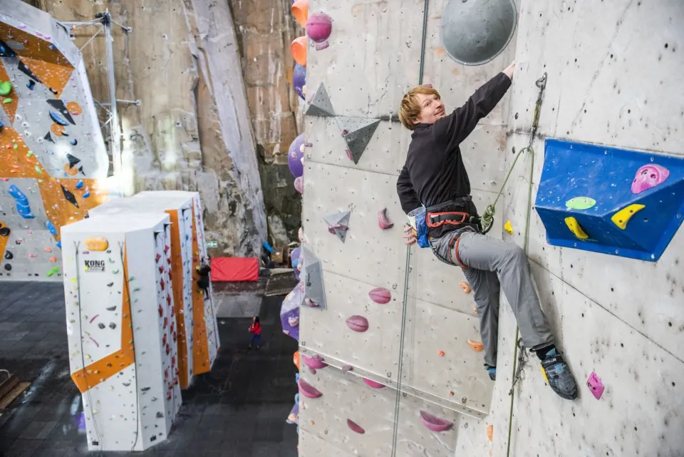 Lead climber clipping on the arena wall