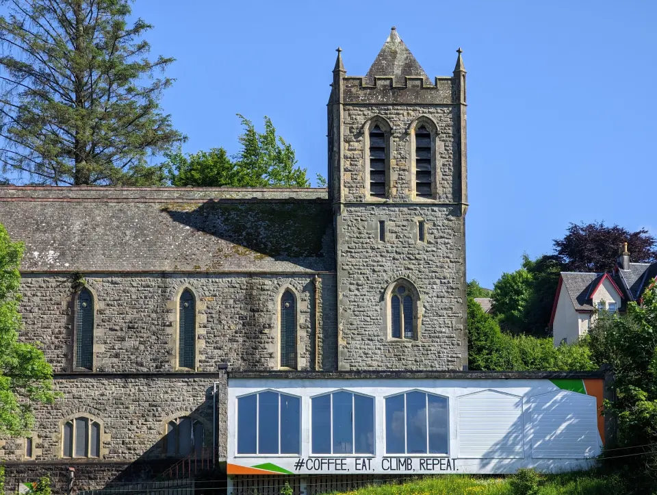 The converted stone church with its tower and the café extension