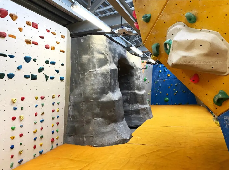 Grey boulder and bouldering walls under the loft roof