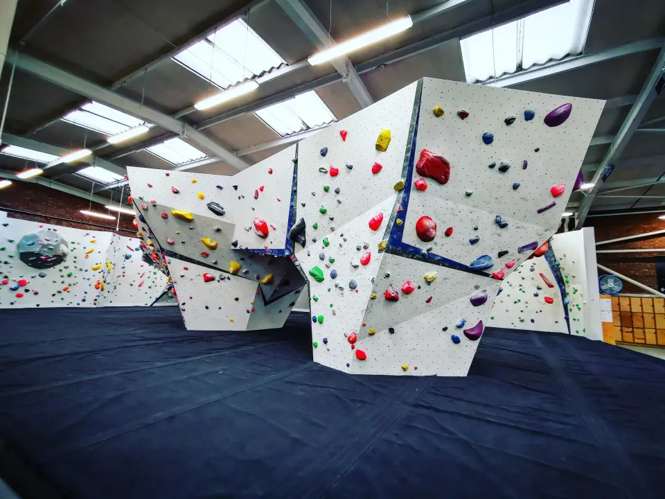 Angular bouldering towers under the warehouse roof