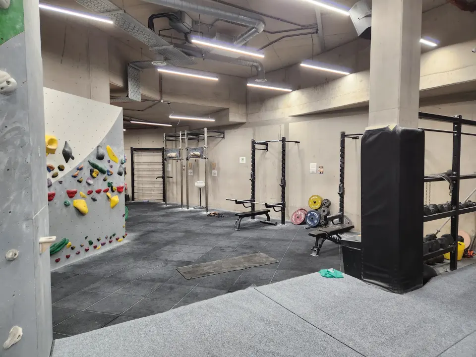 Weights racks in the gym area beside the walls