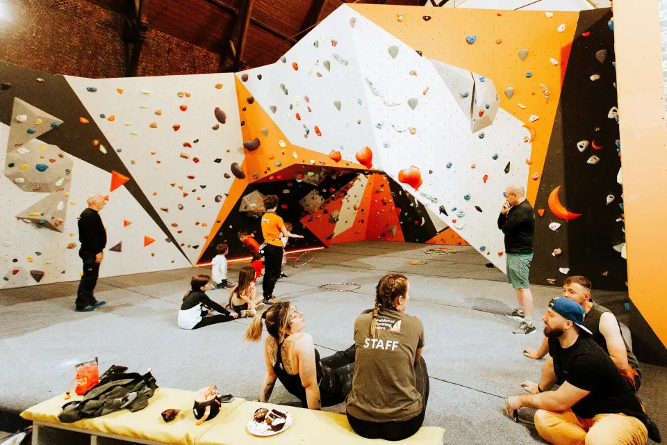Climbers resting on a bench in front of the main bouldering area