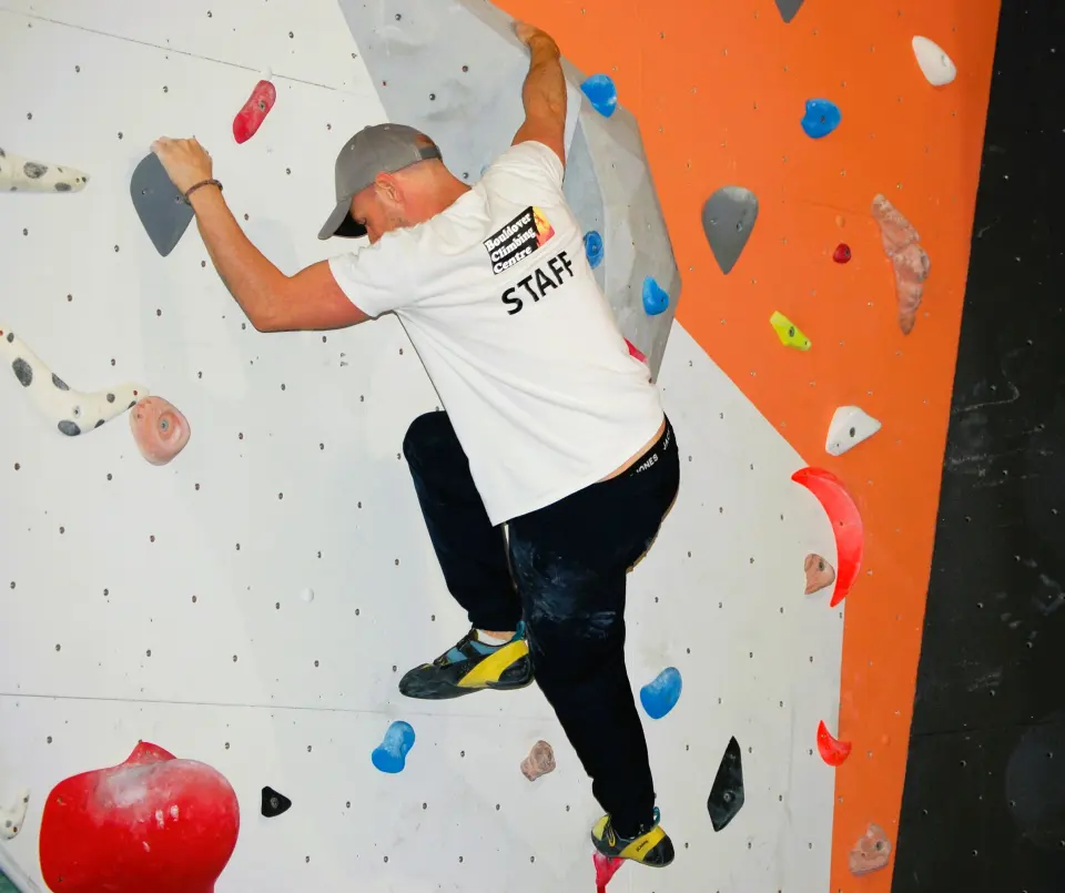Climber reaching past a large volume