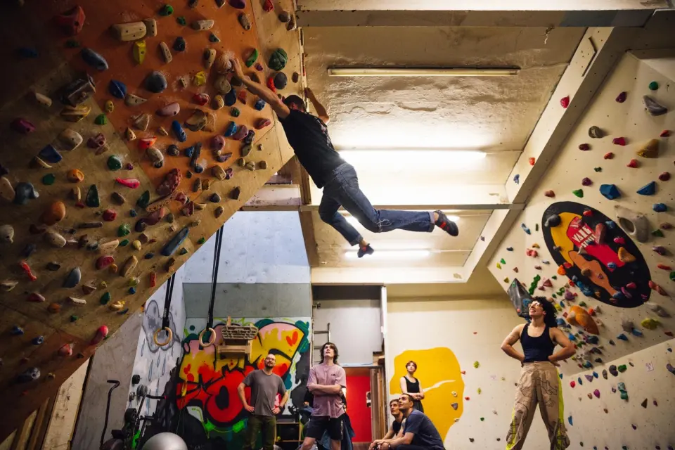 Climber reaching across the overhanging bouldering wall