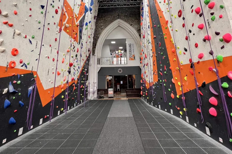 Roped walls lining the nave of the former church, looking towards the entrance arch