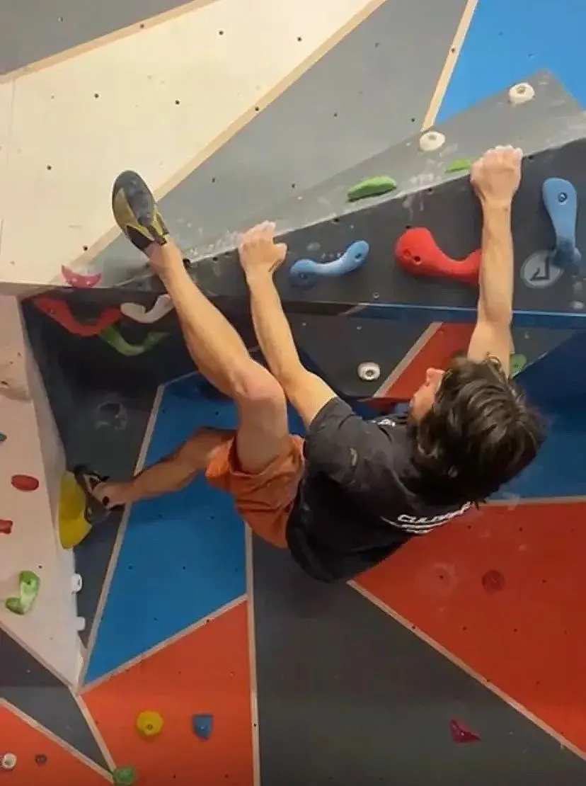 Climber heel-hooking on an overhang