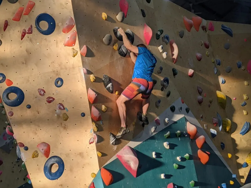 Climber in a corner of the bouldering wall
