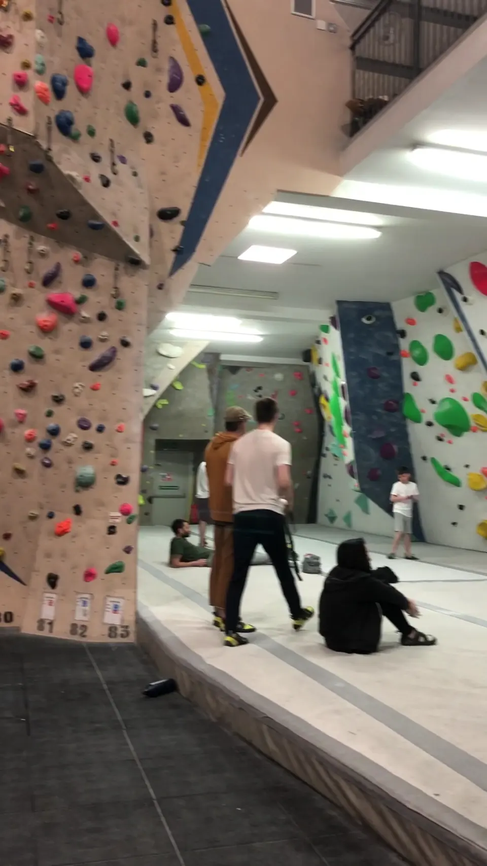 Bouldering walls along a matted corridor