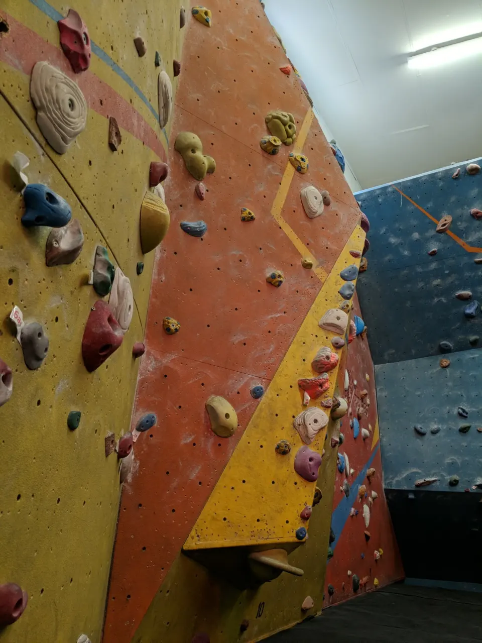 Steep orange and yellow bouldering wall