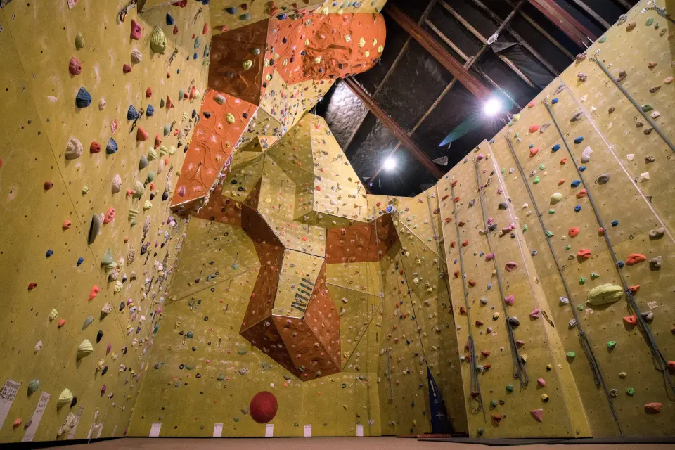 Tall yellow rope walls with an orange overhanging feature in the main hall