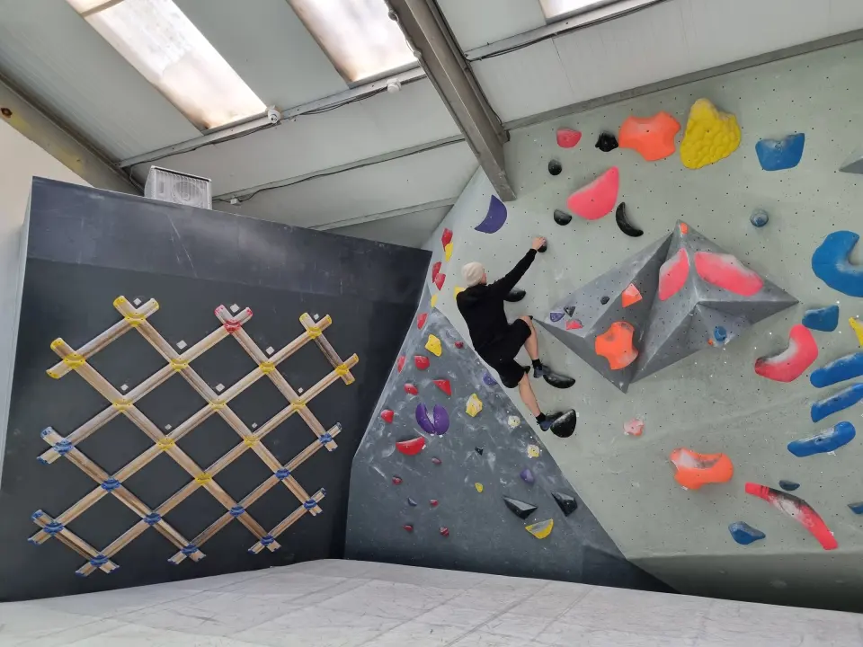 Bouldering room with a lattice board and steep wall
