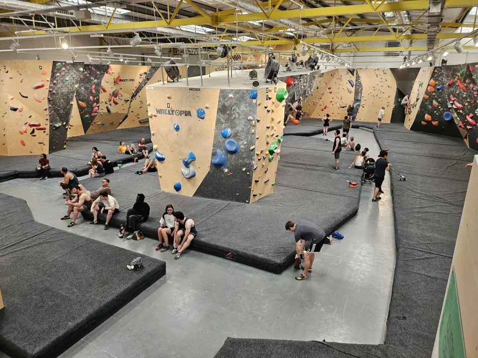 Bouldering floor with padded matting and a central tower