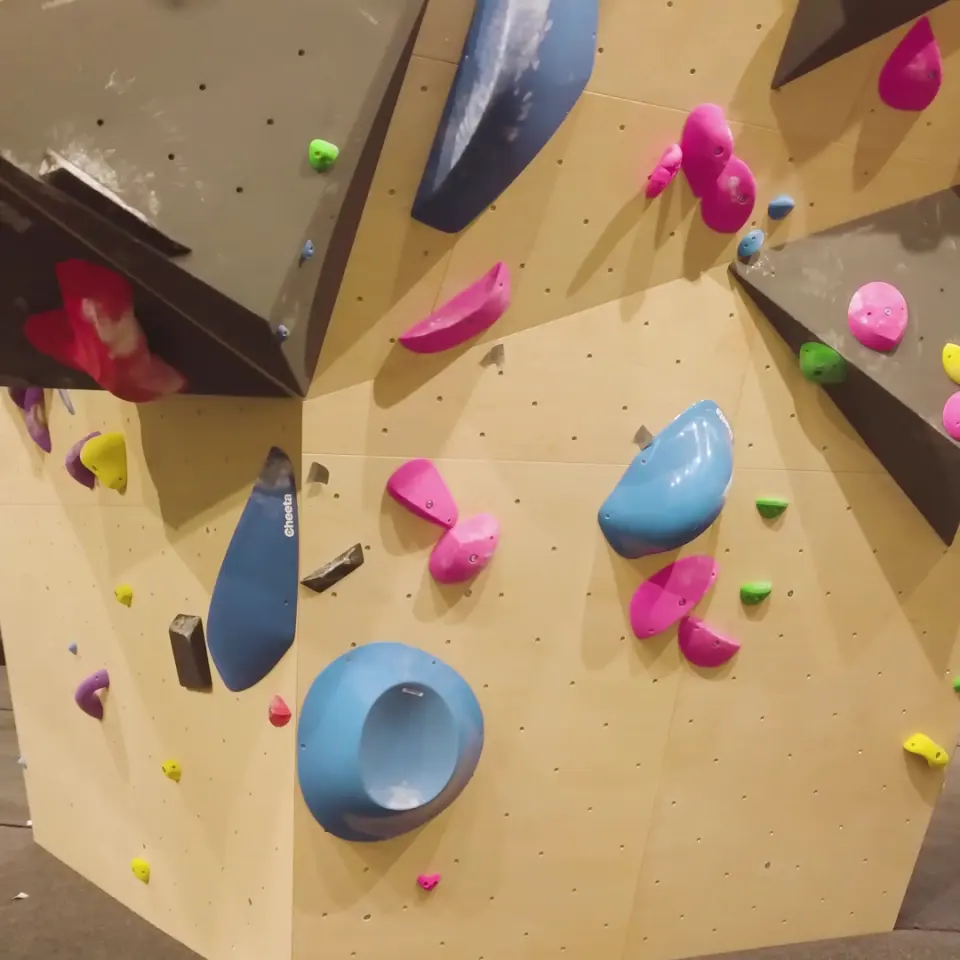 Pink and blue holds and volumes on an angled panel