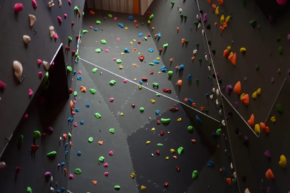Looking up the dark grey lead walls with coloured holds