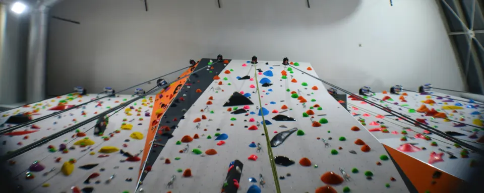 Looking up the white roped walls with orange and black panels