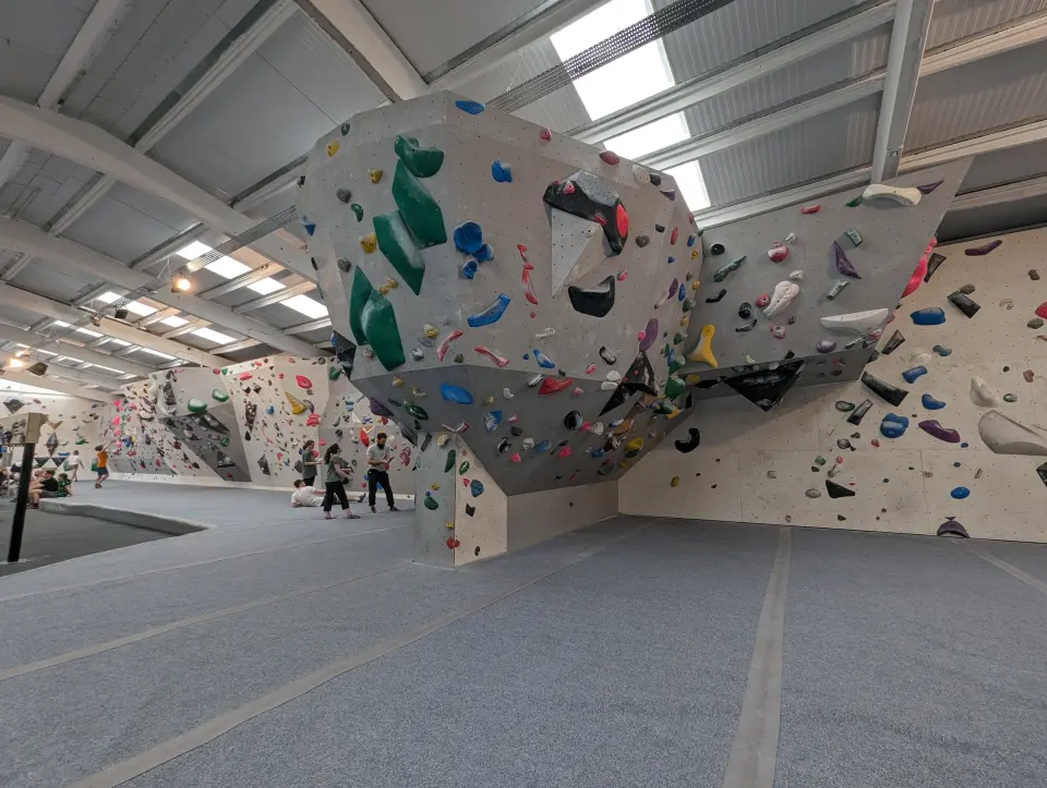 Bouldering hall with a hanging feature and grey matting