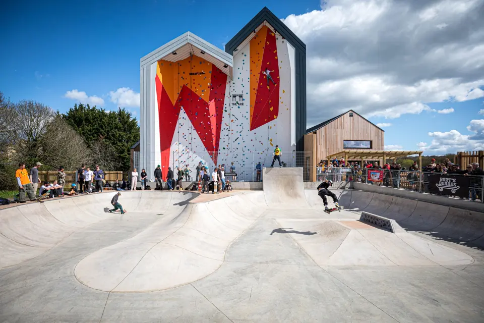 Outdoor climbing wall towers above the skatepark