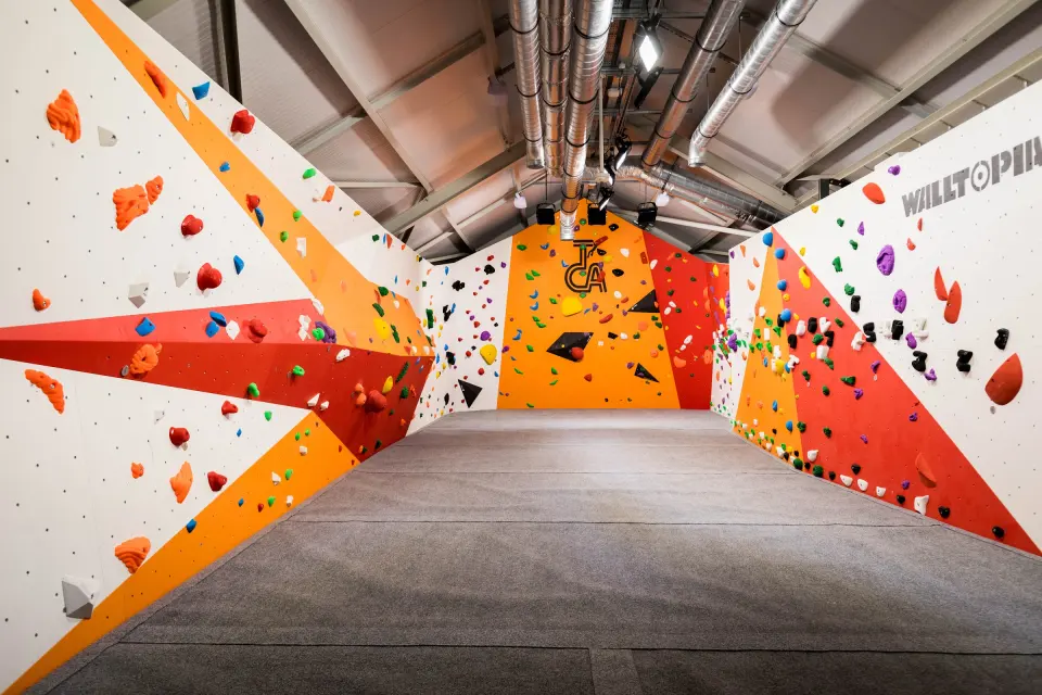 Bouldering room with orange and red angled panels