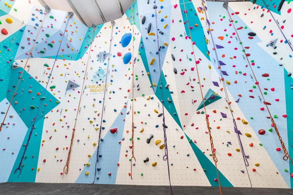Roped walls with teal and blue panels and hanging ropes
