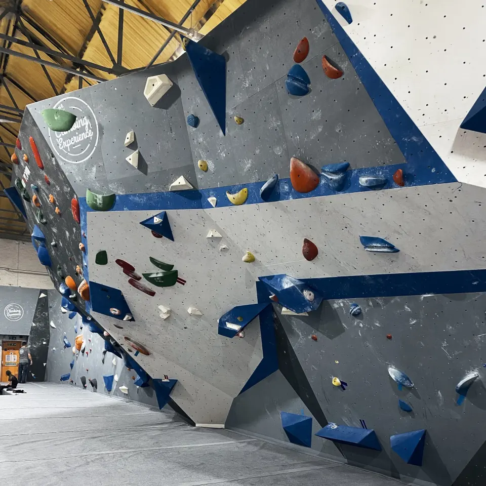 Grey and blue bouldering wall with volumes