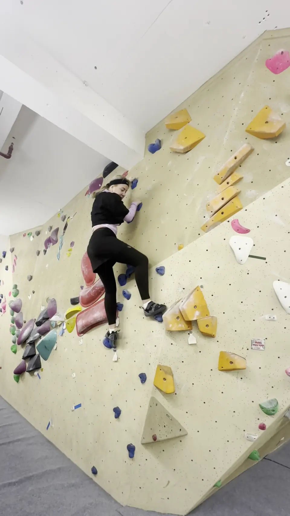 Climber on a slab with yellow volumes