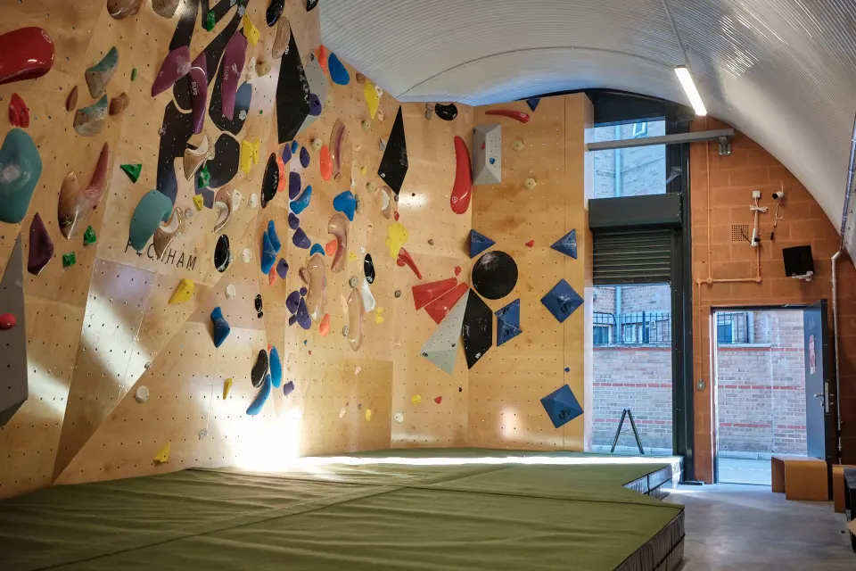 Plywood bouldering walls under the curved railway arch