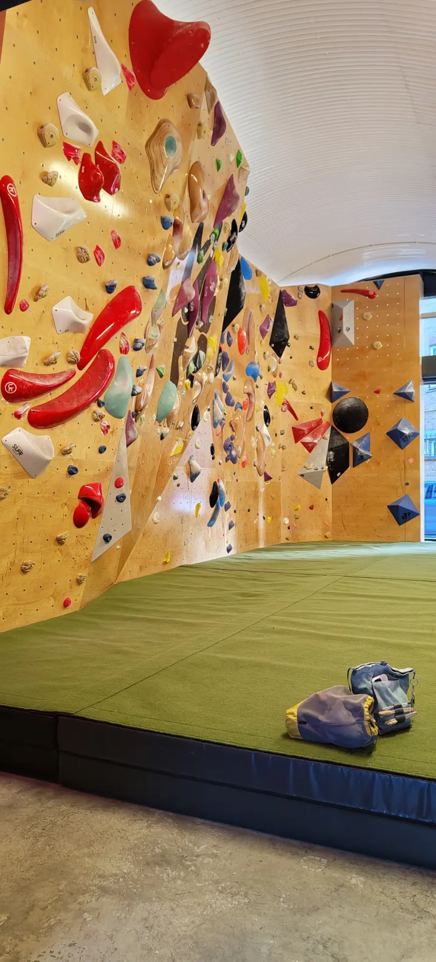 Bouldering wall and green matting
