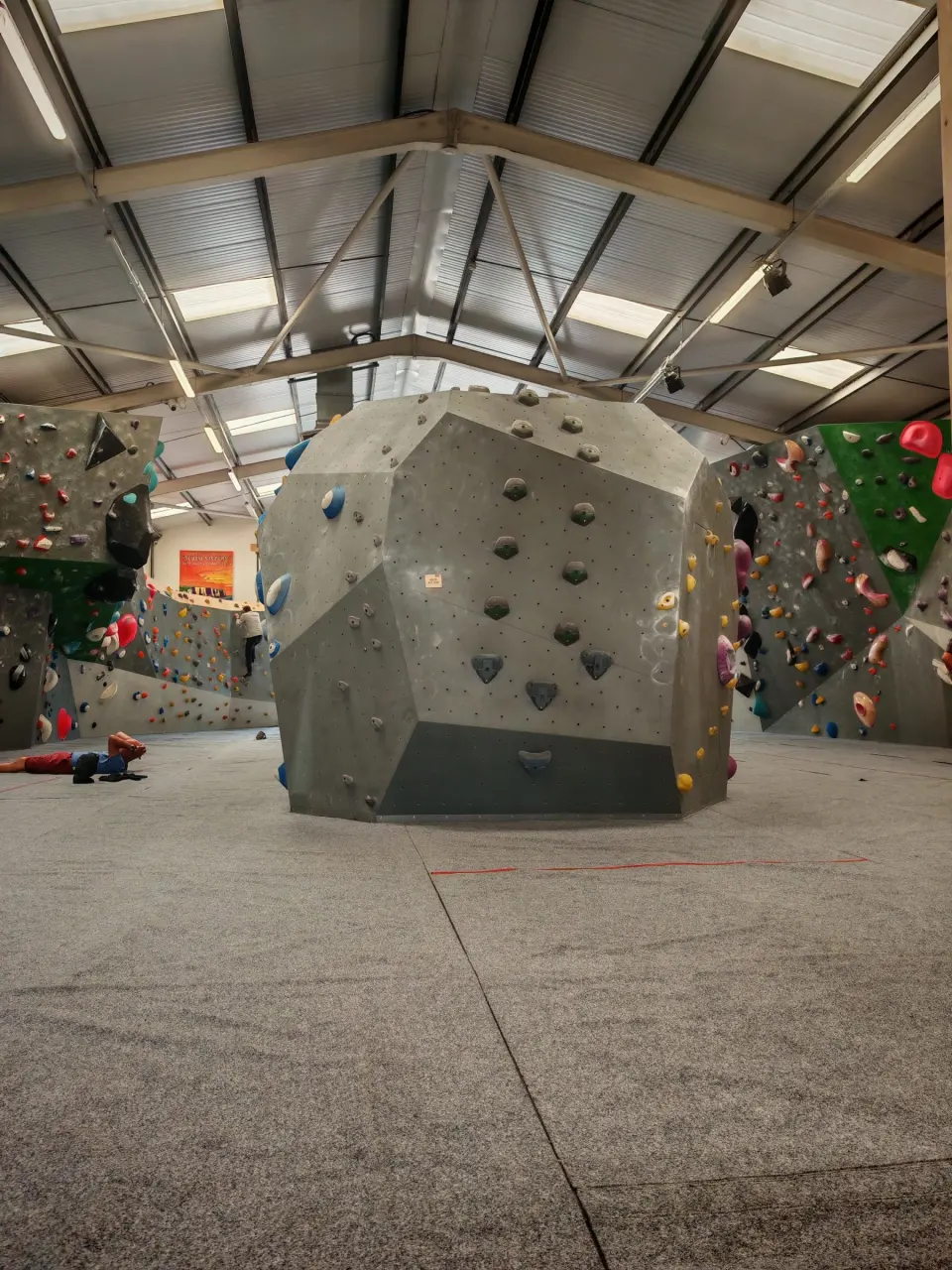 Central boulder and surrounding walls under the warehouse roof