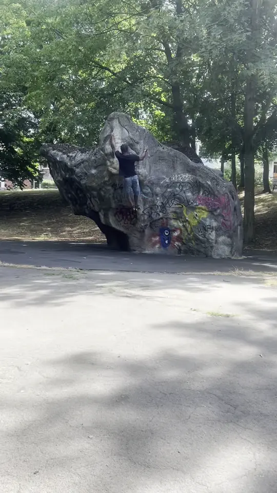 Climber on the main face of the boulder