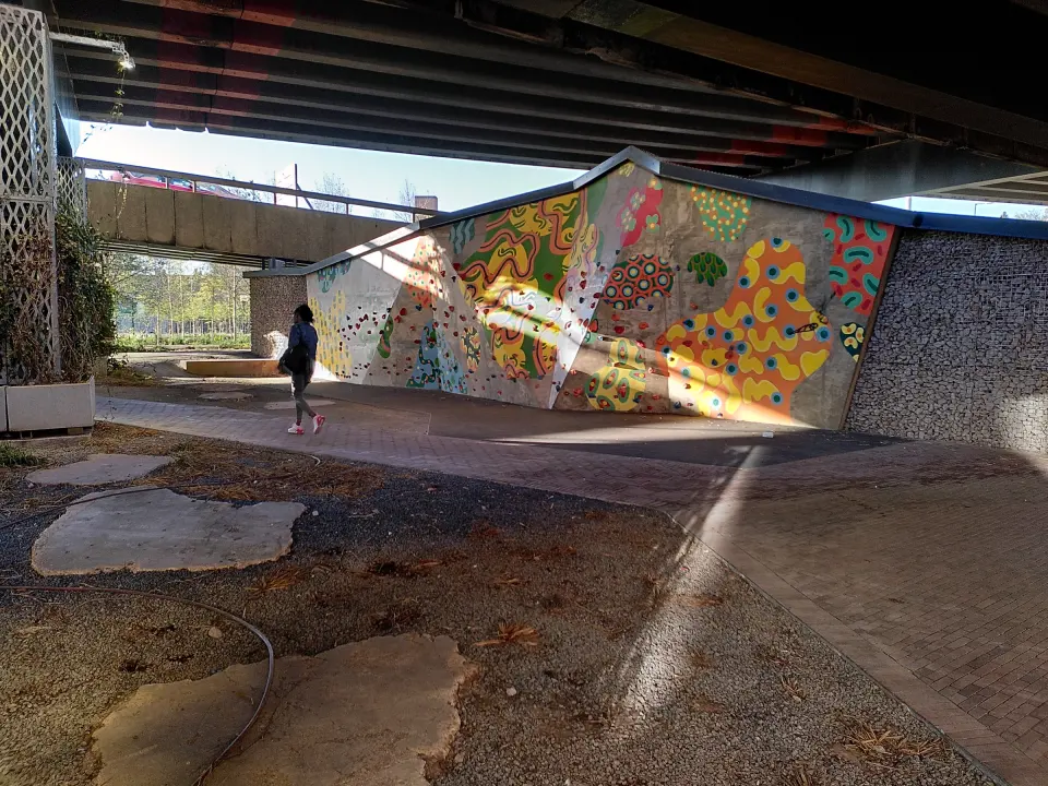 Brightly painted outdoor bouldering wall in the Naul's Mill underpass beneath Coventry's ring road