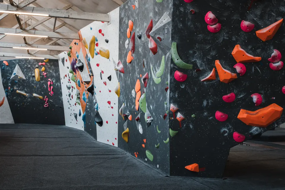 Bouldering walls with grey and white panels and orange holds at Bloc10 Dundee