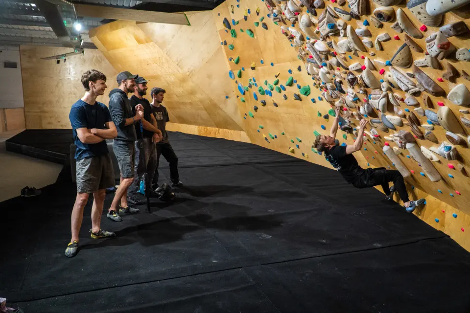 A climber on a steep bouldering wall at Highball Climbing Centre in Norwich