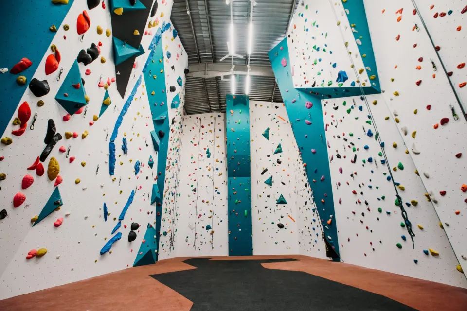 Roped climbing walls with coloured holds at Big Rock Hub in Milton Keynes