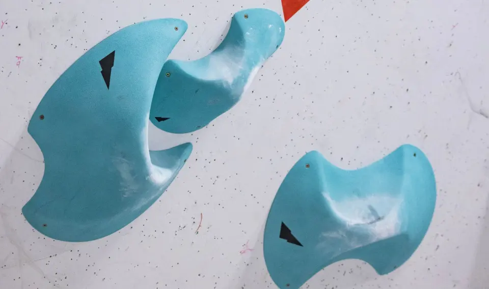 Turquoise holds on the white competition wall at Boulder UK in Preston
