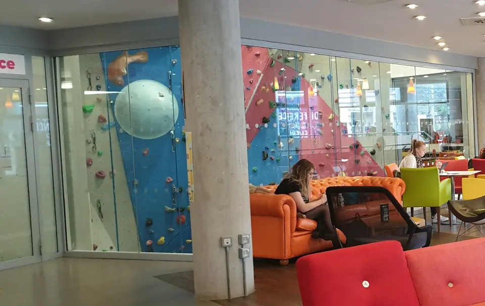 The glass-fronted climbing wall seen from the Students' Union foyer
